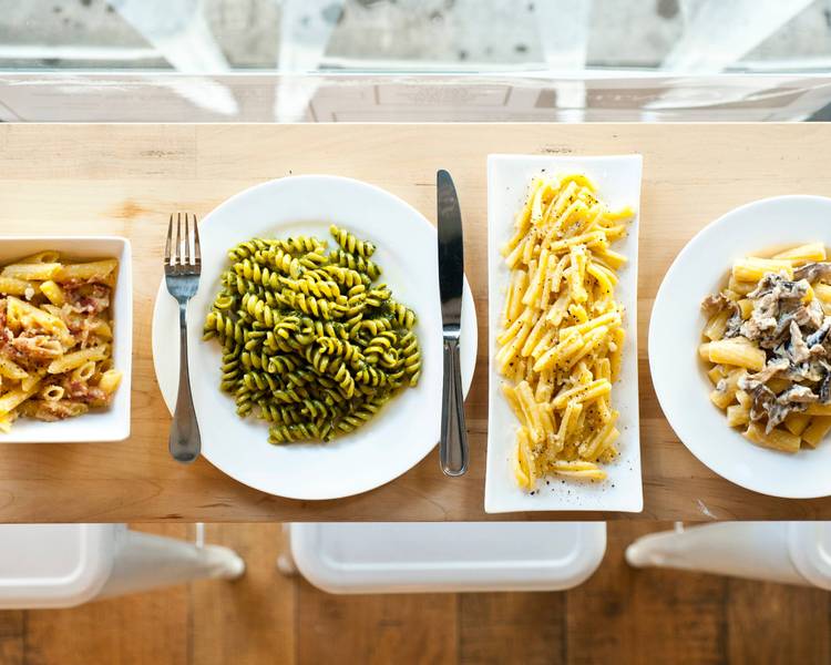 Glorietta signature dishes Handmade Pasta (e.g., Campanelle), Elk Bolognese, Wood-Fired Oysters, Arancini